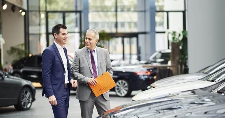 Two men walking to vehicle