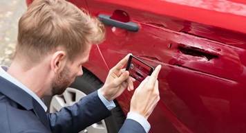 man taking photos of car accident