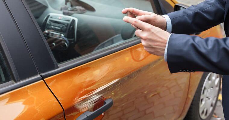 Man taking photo of vehicle