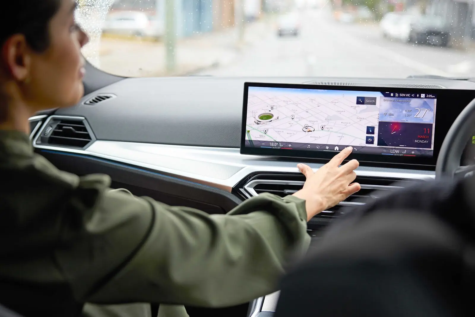 woman in a car - using touchscreen