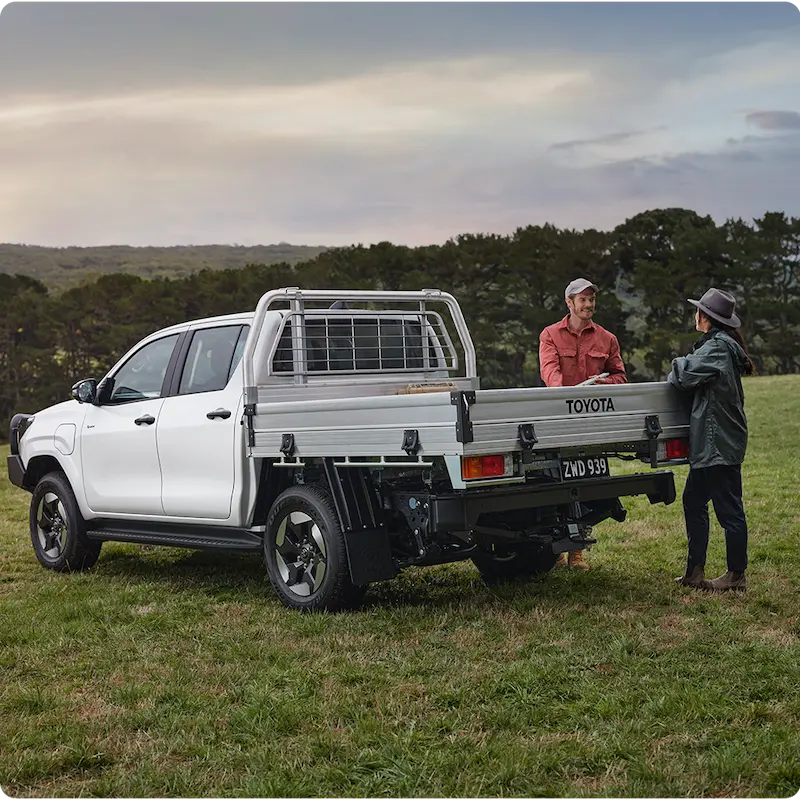 Two people with Toyota pickup truck outdoors