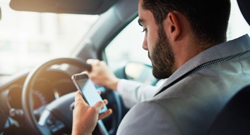 Man driving while on phone