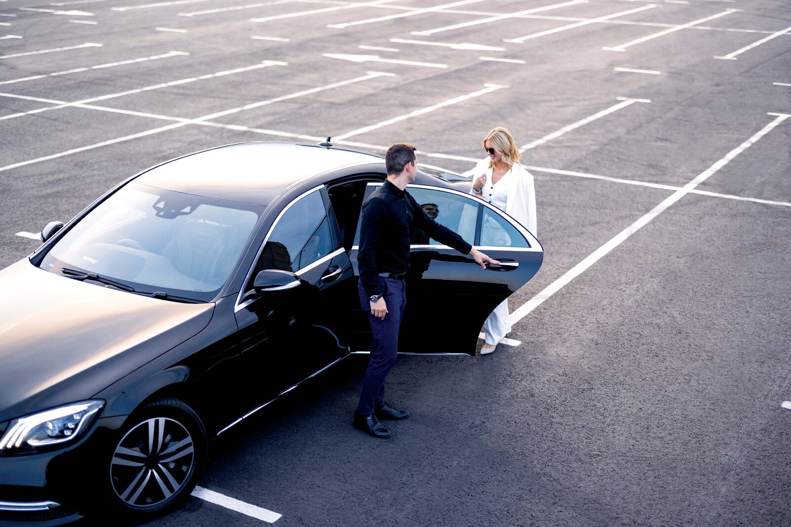 Person opening a vehicle door for someone else