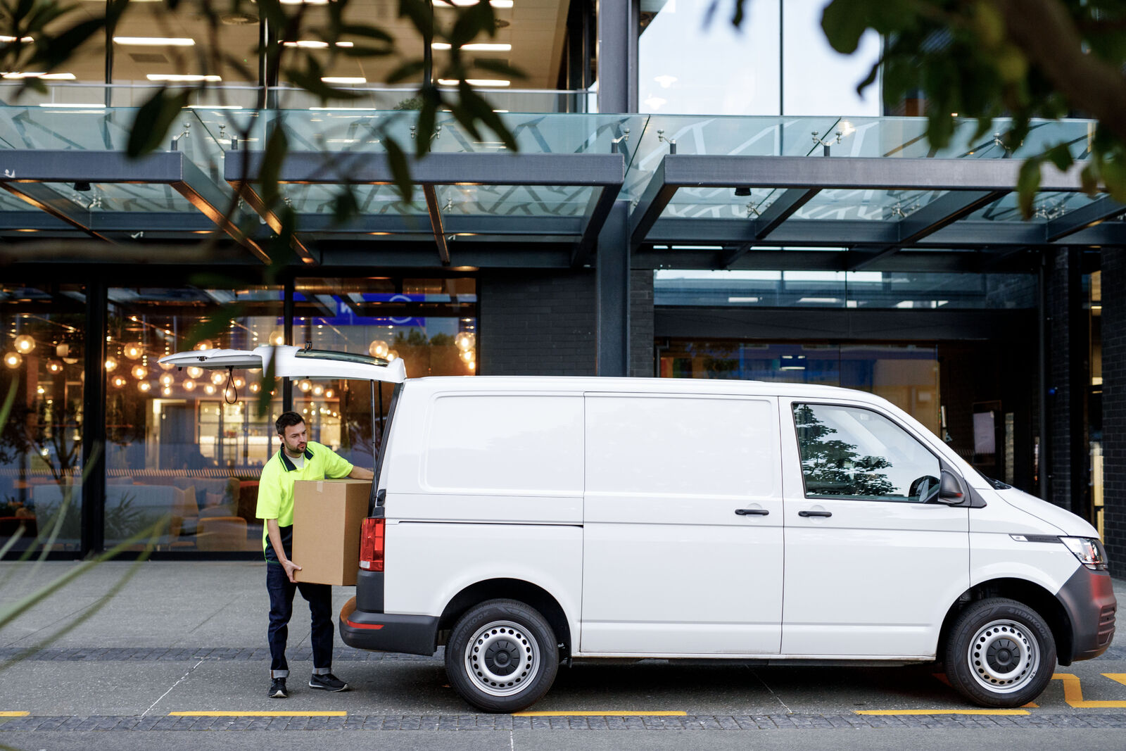 Delivery driver unloading a box from a commercial van in NZ city