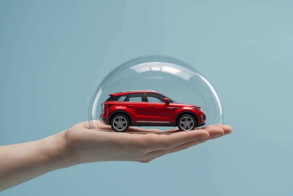 Red car protected under a glass dome, symbolising the security of OEM car parts, car manufacturing quality and fleet company support.